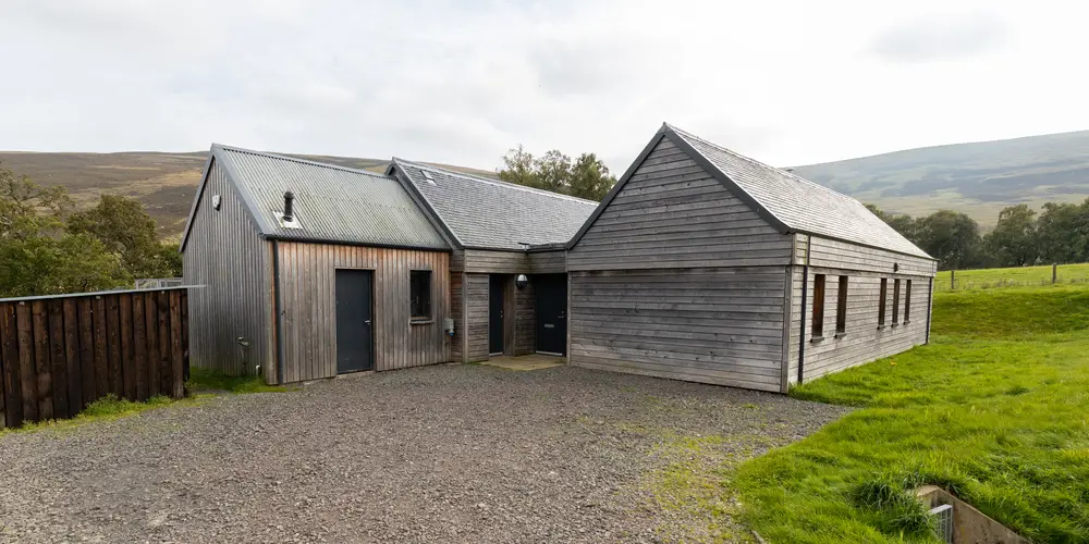 a wooden building with a garage 