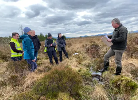 Staff members standing on a peatbog 