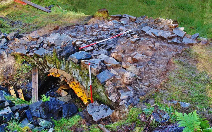 Archaeological tools on the exposed stonework of Achlain Bridge