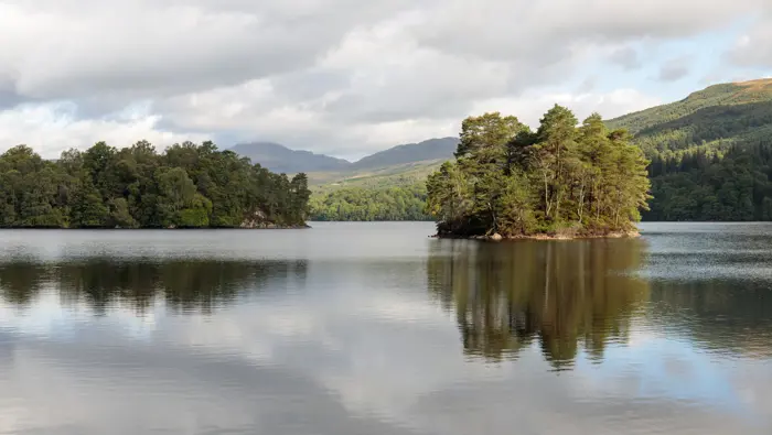 Looking to the north side of Loch Katrine with an island of trees in the image.