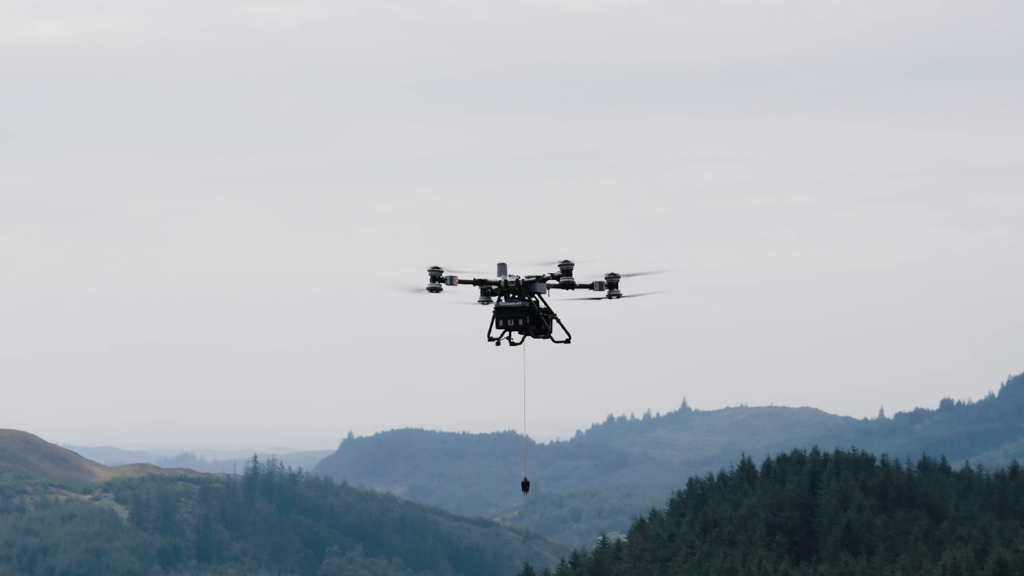 Heavy-lift drone with hook lowered.