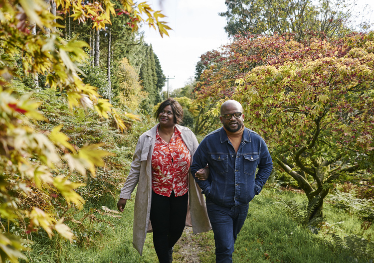 Man and woman stroll together through Kilmun Arboretum