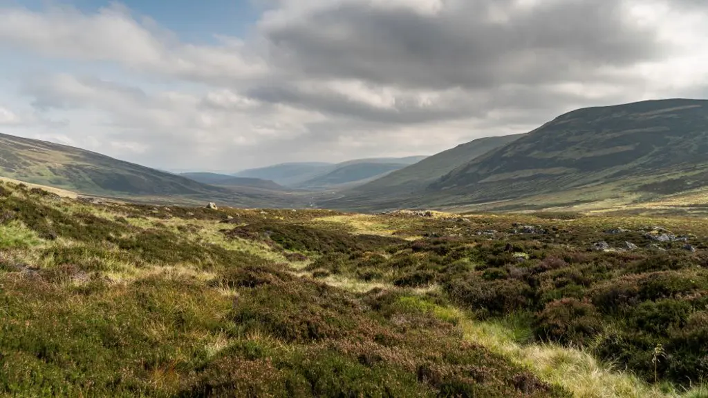View looking down a valley between hills with more hills in the distance. 
