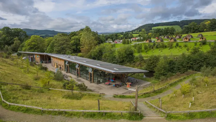 Visitor centre in a landscape of trees and fields.